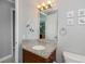 Granite vanity in neutral bathroom with custom seashell decor and wood cabinets, offering an elegant space at 13471 Chenille Dr, Port Charlotte, FL 33981