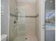 Shower featuring glass door, tiled accent, and a door to the pool area at 13471 Chenille Dr, Port Charlotte, FL 33981