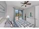 Comfortable bedroom with fan, and view of the pool area through sliding glass doors at 13471 Chenille Dr, Port Charlotte, FL 33981