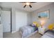 Cozy bedroom with twin beds, ceiling fan, beach themed artwork, and light walls for a comfortable vibe at 13471 Chenille Dr, Port Charlotte, FL 33981