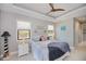Bright bedroom with modern decor featuring a tray ceiling, coastal accents, and abundant natural light at 13471 Chenille Dr, Port Charlotte, FL 33981