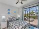 Light and airy bedroom features a large sliding glass door that opens to the pool area at 13471 Chenille Dr, Port Charlotte, FL 33981