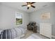 Comfortable bedroom with twin beds, a workspace with dual monitors, window views and woven storage at 13471 Chenille Dr, Port Charlotte, FL 33981