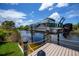 Close-up view of the boat lift on the canal and the adjacent dock at 13471 Chenille Dr, Port Charlotte, FL 33981