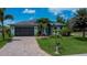 Beautiful home showcasing a charming design, well-kept landscaping, and a welcoming driveway at 13471 Chenille Dr, Port Charlotte, FL 33981