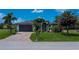 Inviting home with a paved driveway, two-car garage, and well-kept lawn at 13471 Chenille Dr, Port Charlotte, FL 33981