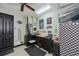 Well-equipped garage features a TV, checkered wall, work station and sleek tool storage, perfect for projects at 13471 Chenille Dr, Port Charlotte, FL 33981