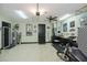 Spacious, organized garage, includes a workbench, motorcycle, and a checkered accent wall, for hobbyists and car enthusiasts at 13471 Chenille Dr, Port Charlotte, FL 33981