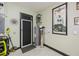 Garage area with utility access, featuring a hot water heater, fan, and Dale Earnhardt memorabilia for added appeal at 13471 Chenille Dr, Port Charlotte, FL 33981