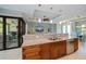 Kitchen with granite countertops, wood cabinetry and views of the lanai and formal dining area at 13471 Chenille Dr, Port Charlotte, FL 33981