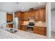 Kitchen with stainless steel appliances, wood cabinetry, and granite countertops at 13471 Chenille Dr, Port Charlotte, FL 33981