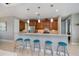 Kitchen breakfast bar with granite countertops and seating for four beneath pendant lighting at 13471 Chenille Dr, Port Charlotte, FL 33981