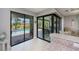 Open living space with sliding glass doors to the lanai and pool at 13471 Chenille Dr, Port Charlotte, FL 33981