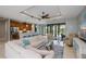 Spacious living room leading to a kitchen and featuring a pool view through sliding glass doors at 13471 Chenille Dr, Port Charlotte, FL 33981
