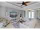 Open-concept living room featuring stylish decor, tile floors, and a comfortable sectional sofa at 13471 Chenille Dr, Port Charlotte, FL 33981