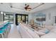 Bright living room boasts a tray ceiling with ceiling fan, tile flooring, and sliding glass doors to the pool area at 13471 Chenille Dr, Port Charlotte, FL 33981