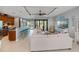 Open-concept living room with a seamless flow to the outdoor pool area through sliding glass doors and a breakfast bar at 13471 Chenille Dr, Port Charlotte, FL 33981
