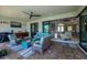 Relaxing covered patio with comfortable seating, outdoor kitchen, and sliding glass doors for seamless indoor-outdoor living at 13471 Chenille Dr, Port Charlotte, FL 33981