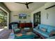 Comfortable covered patio with TV, kitchenette, and cozy seating create the perfect outdoor entertaining space at 13471 Chenille Dr, Port Charlotte, FL 33981
