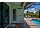 Outdoor shower access to a beautiful screened pool with brick deck and lounge chairs create the perfect relaxation space at 13471 Chenille Dr, Port Charlotte, FL 33981