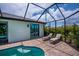 Relaxing screened-in pool area with lounge chairs, brick pavers, and access from the house at 13471 Chenille Dr, Port Charlotte, FL 33981