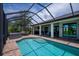 Relaxing screened pool and spa with lush landscaping create a serene and private outdoor escape at 13471 Chenille Dr, Port Charlotte, FL 33981