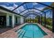 Beautiful screened pool with brick deck and lounge chairs create the perfect outdoor relaxation space at 13471 Chenille Dr, Port Charlotte, FL 33981