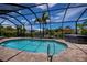 Relaxing screened-in pool area featuring a private hot tub and sunny skies at 13471 Chenille Dr, Port Charlotte, FL 33981