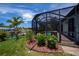 Enjoy outdoor living in this spacious screened-in porch with a beautiful view of the pool and landscaping at 13471 Chenille Dr, Port Charlotte, FL 33981