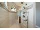 Shower featuring dual shower heads, mosaic tile accent and small arched window at 13471 Chenille Dr, Port Charlotte, FL 33981