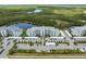 Aerial view of complex near beautiful lakes, lush foliage and a convenient parking area at 14141 Heritage Landing Blvd # 912, Punta Gorda, FL 33955