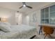Comfortable bedroom with ceiling fan, desk, and ample natural light from the large window at 14141 Heritage Landing Blvd # 912, Punta Gorda, FL 33955