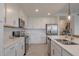 Bright kitchen featuring white cabinets, stainless appliances, and quartz countertops at 14141 Heritage Landing Blvd # 912, Punta Gorda, FL 33955