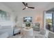 Bright and airy living room featuring modern furnishings, a ceiling fan, and views of the serene pond at 14141 Heritage Landing Blvd # 912, Punta Gorda, FL 33955