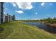 Scenic view of a calm pond surrounded by lush greenery, offering a tranquil and serene setting at 14141 Heritage Landing Blvd # 912, Punta Gorda, FL 33955