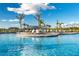Beautiful pool with an island for lounging and relaxing under the sun and the palm trees at 14141 Heritage Landing Blvd # 912, Punta Gorda, FL 33955