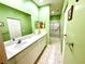 Bright bathroom featuring double sinks, a large mirror, and a separate shower at 1431 Red Oak Ln, Port Charlotte, FL 33948