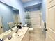 Bathroom features a tub with a shower, vanity, and neutral color palette at 1431 Red Oak Ln, Port Charlotte, FL 33948