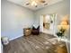 Bedroom featuring hardwood floors, a ceiling fan, and view to kitchen at 1431 Red Oak Ln, Port Charlotte, FL 33948