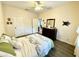 Bright bedroom with a ceiling fan, dresser, and a beautifully decorated bed with green accents at 1431 Red Oak Ln, Port Charlotte, FL 33948