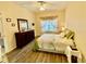 Bedroom with hardwood floors, a dresser, and large bed at 1431 Red Oak Ln, Port Charlotte, FL 33948