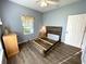 Comfortable bedroom offers a neutral palette, hardwood floors, and natural light at 1431 Red Oak Ln, Port Charlotte, FL 33948