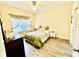 Bedroom showcasing wood floors, a ceiling fan, and a window with decorative curtains at 1431 Red Oak Ln, Port Charlotte, FL 33948