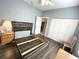 Spacious bedroom features hardwood floors, a closet, and natural light from the window at 1431 Red Oak Ln, Port Charlotte, FL 33948