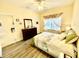 Bedroom with hardwood floors and window dressed with decorative curtains and valance at 1431 Red Oak Ln, Port Charlotte, FL 33948