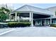 Inviting clubhouse entrance with covered porch, manicured landscaping, and a welcoming atmosphere at 1431 Red Oak Ln, Port Charlotte, FL 33948