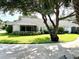 Charming single-story home boasts mature trees, a well-maintained lawn, and a screen room at 1431 Red Oak Ln, Port Charlotte, FL 33948