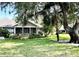 Charming single-story home with screened porch, mature trees, and well-maintained landscaping at 1431 Red Oak Ln, Port Charlotte, FL 33948