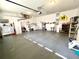 Spacious garage interior features an epoxy floor, overhead lighting, and utility sink at 1431 Red Oak Ln, Port Charlotte, FL 33948