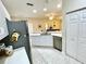 Kitchen view with white cabinets, stainless steel appliances, and a view into the dining area at 1431 Red Oak Ln, Port Charlotte, FL 33948